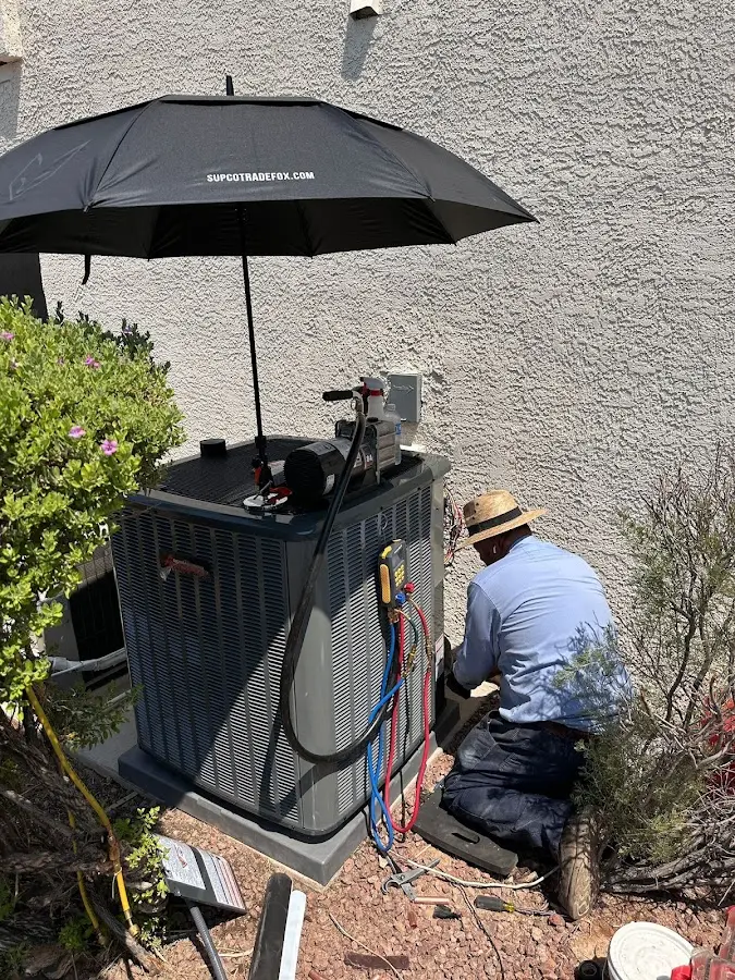 HVAC technician performing outdoor AC maintenance in Crestline
